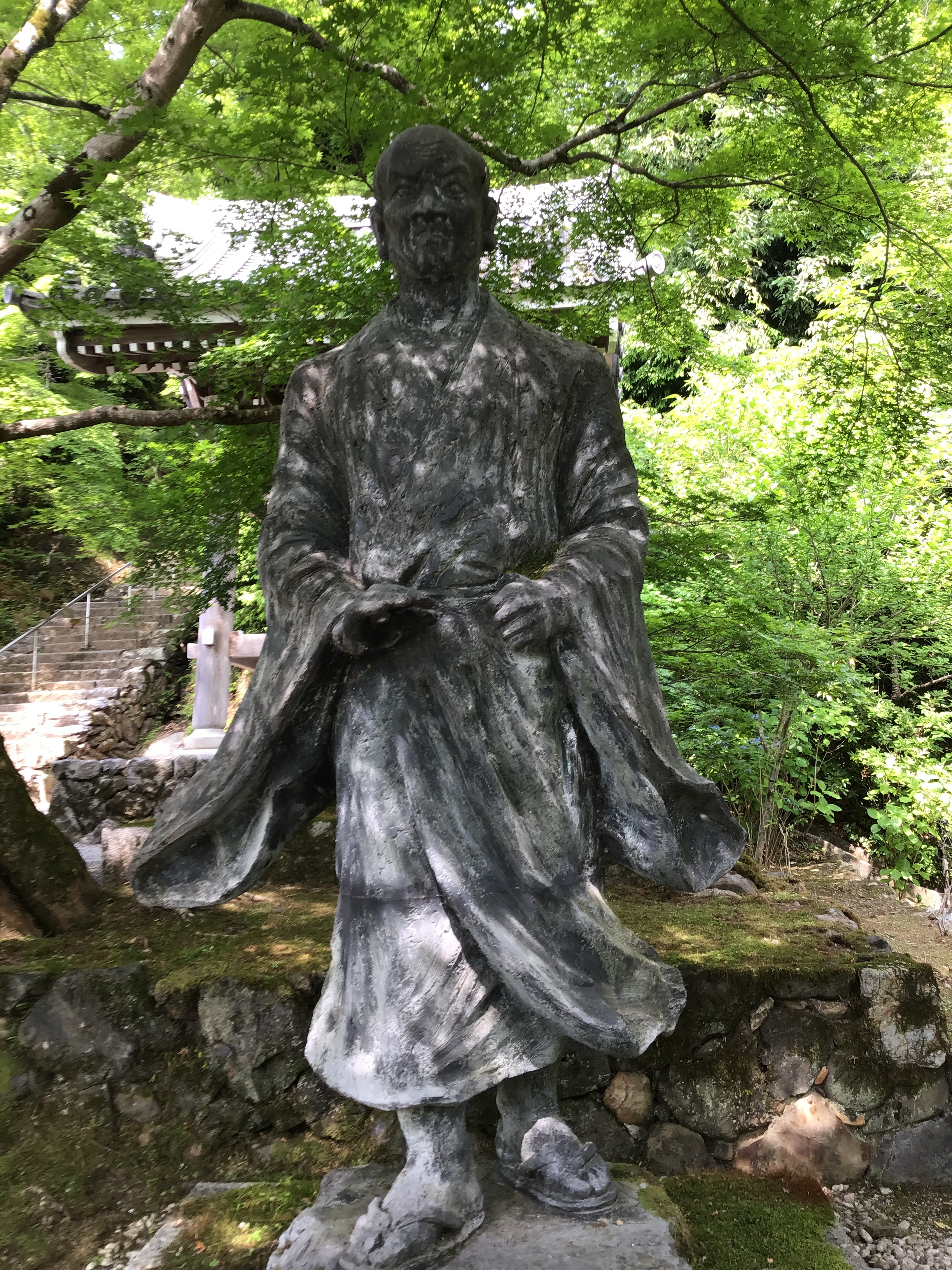 A statue sitting in the shade