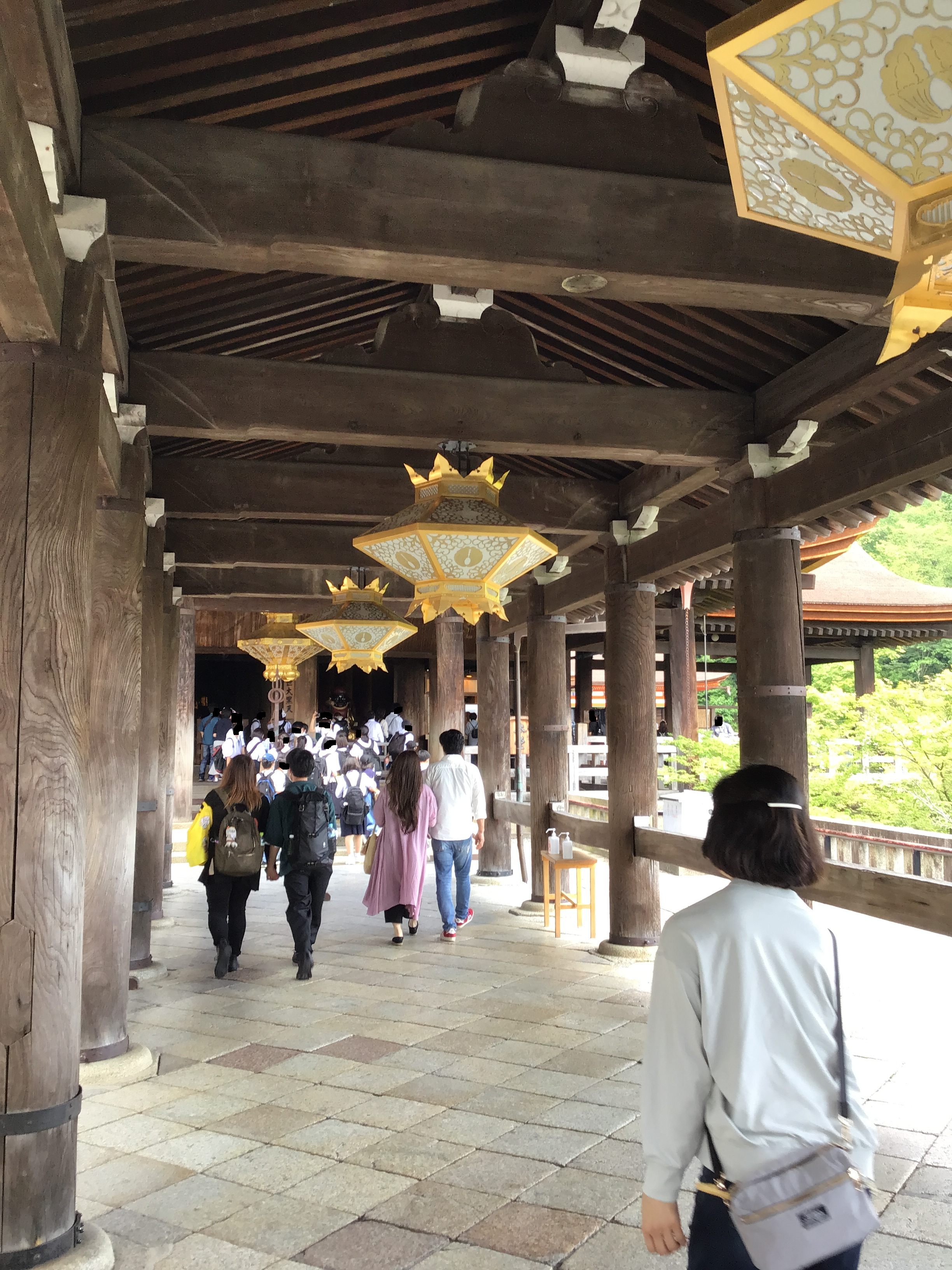 A hallway with golden chandelleers