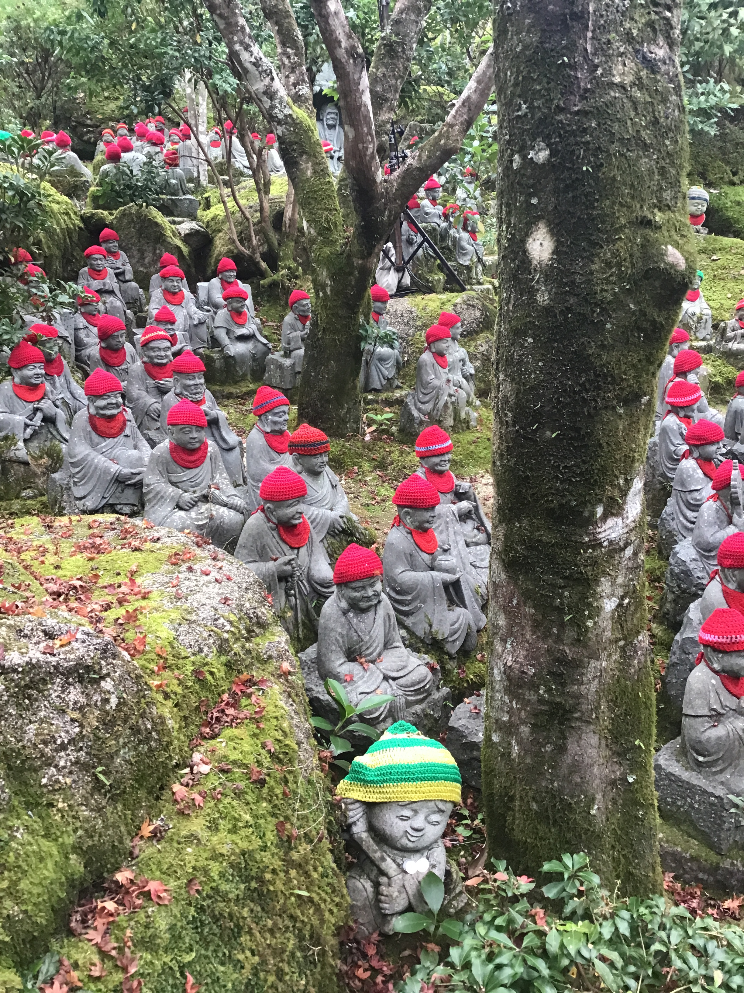 A whole bunch of statues wearing red hats