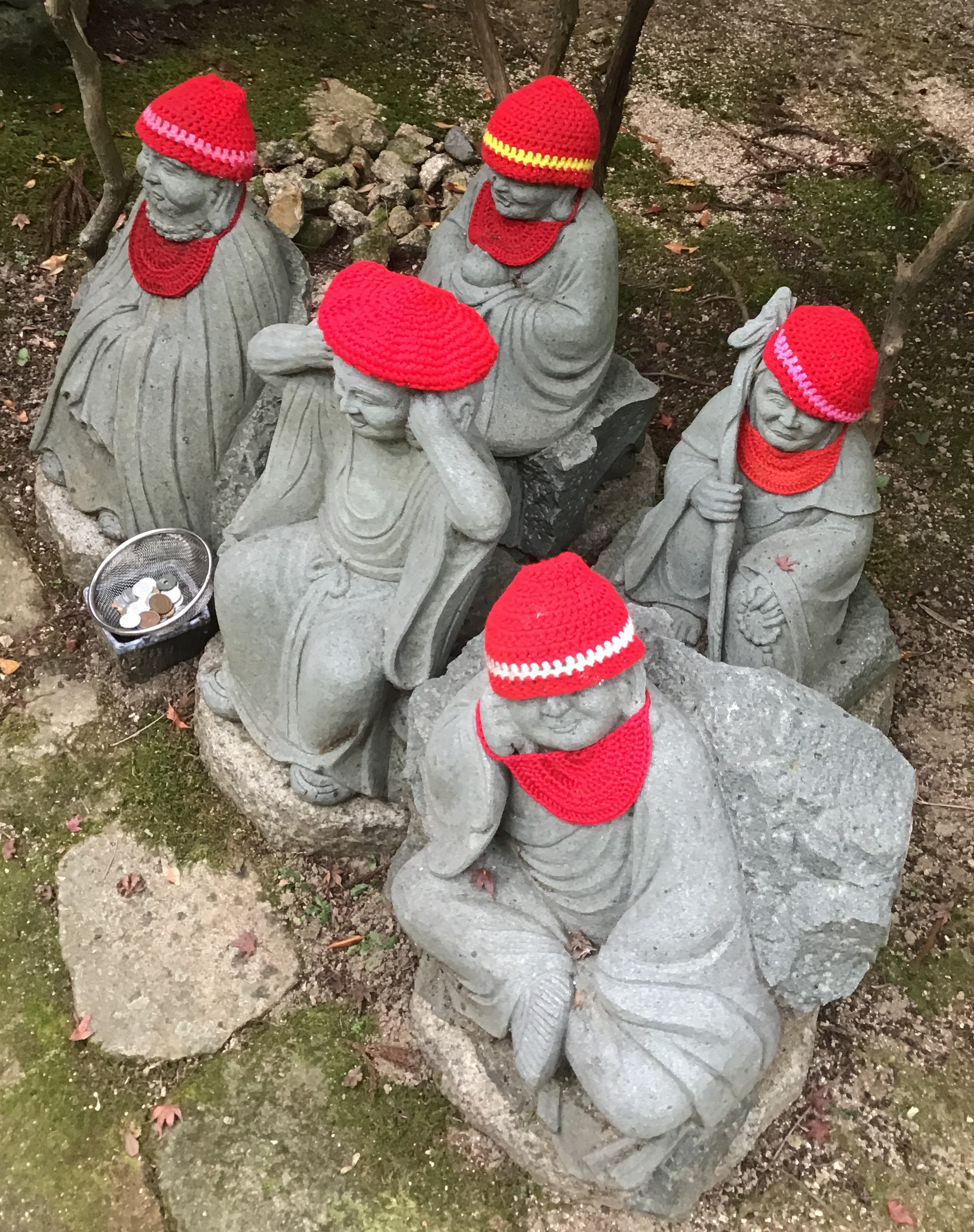 Statues of monks wearing red hats